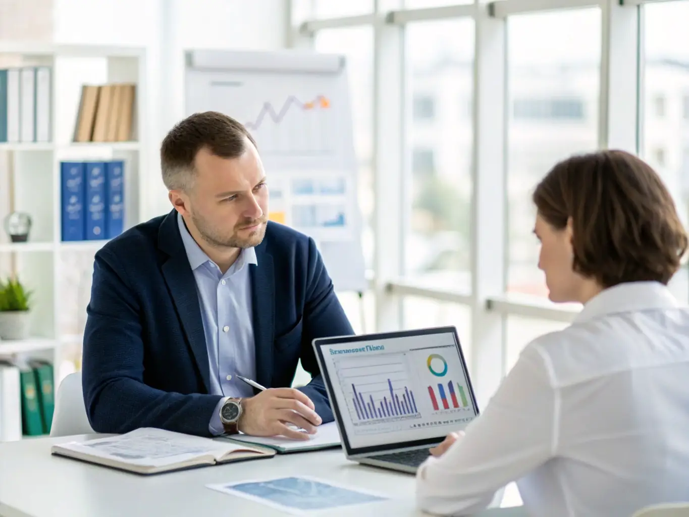 A professional financial advisor discussing wealth management options with a client in an elegant office setting, symbolizing personalized wealth management services.